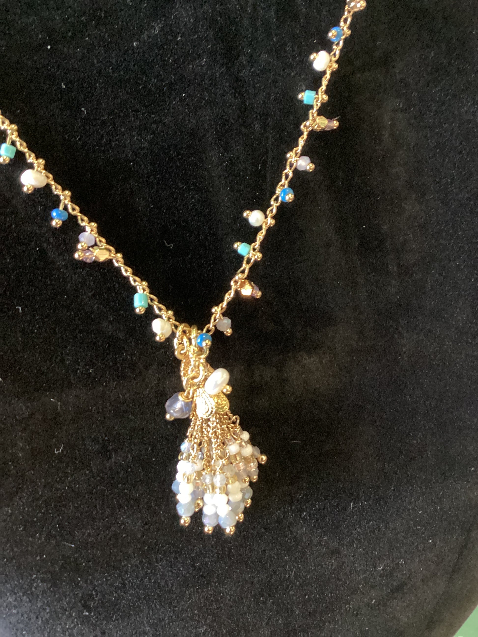 gold necklace with white, blue and torquoise beads